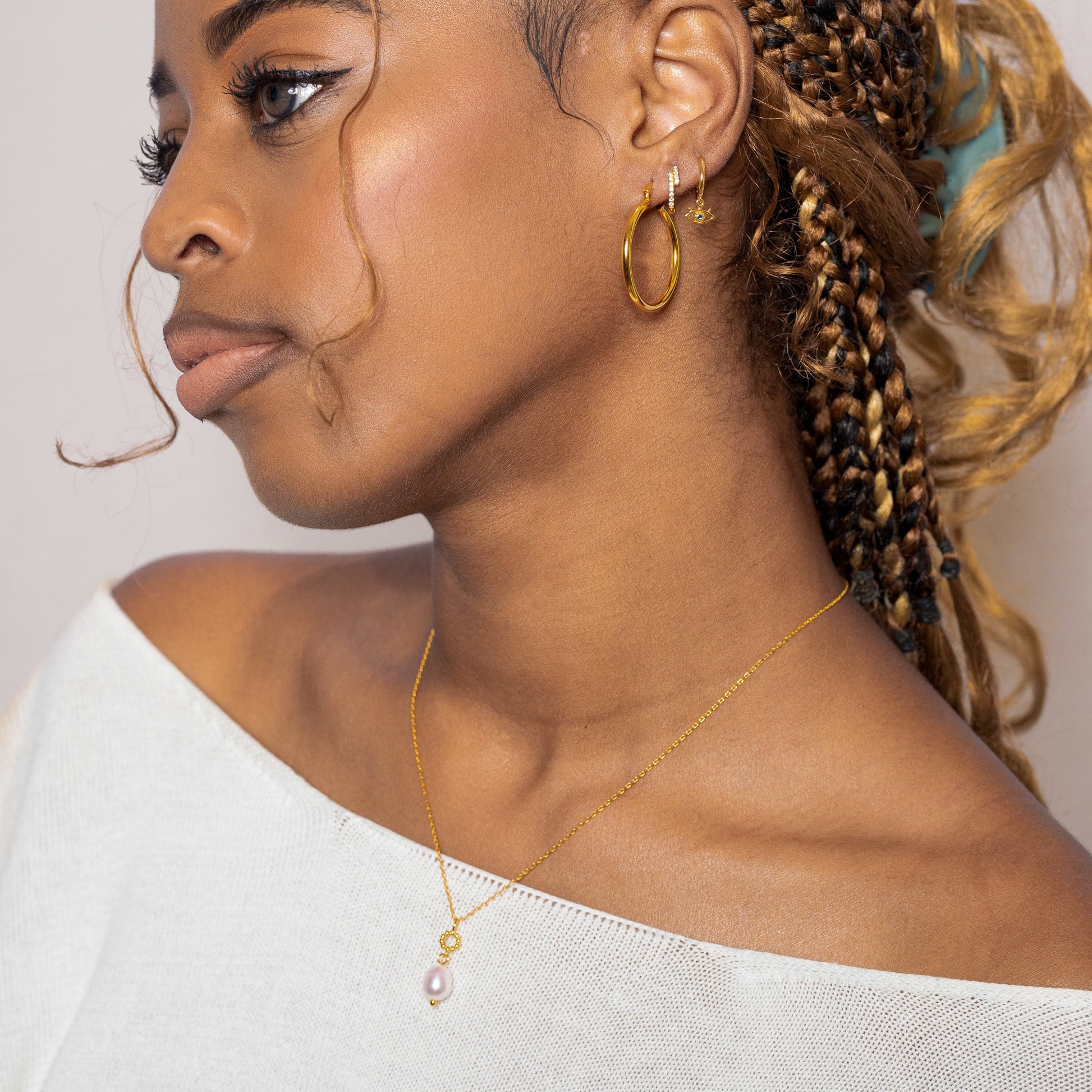 Protector Eyes with Blue Stone Drop Gold Evil Eye Huggie Hoop Earrings by Doviana