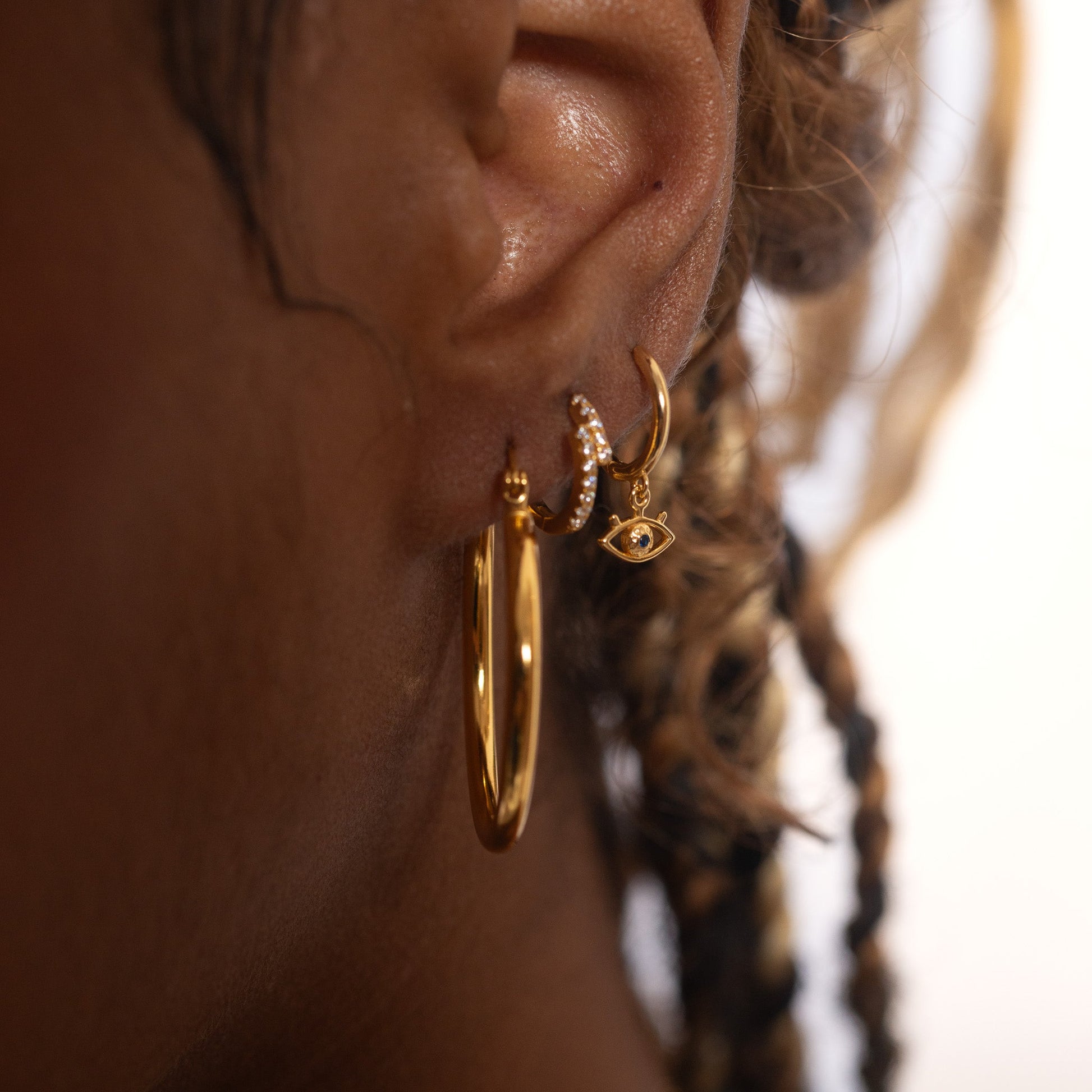 Protector Eyes with Blue Stone Drop Gold Evil Eye Huggie Hoop Earrings by Doviana